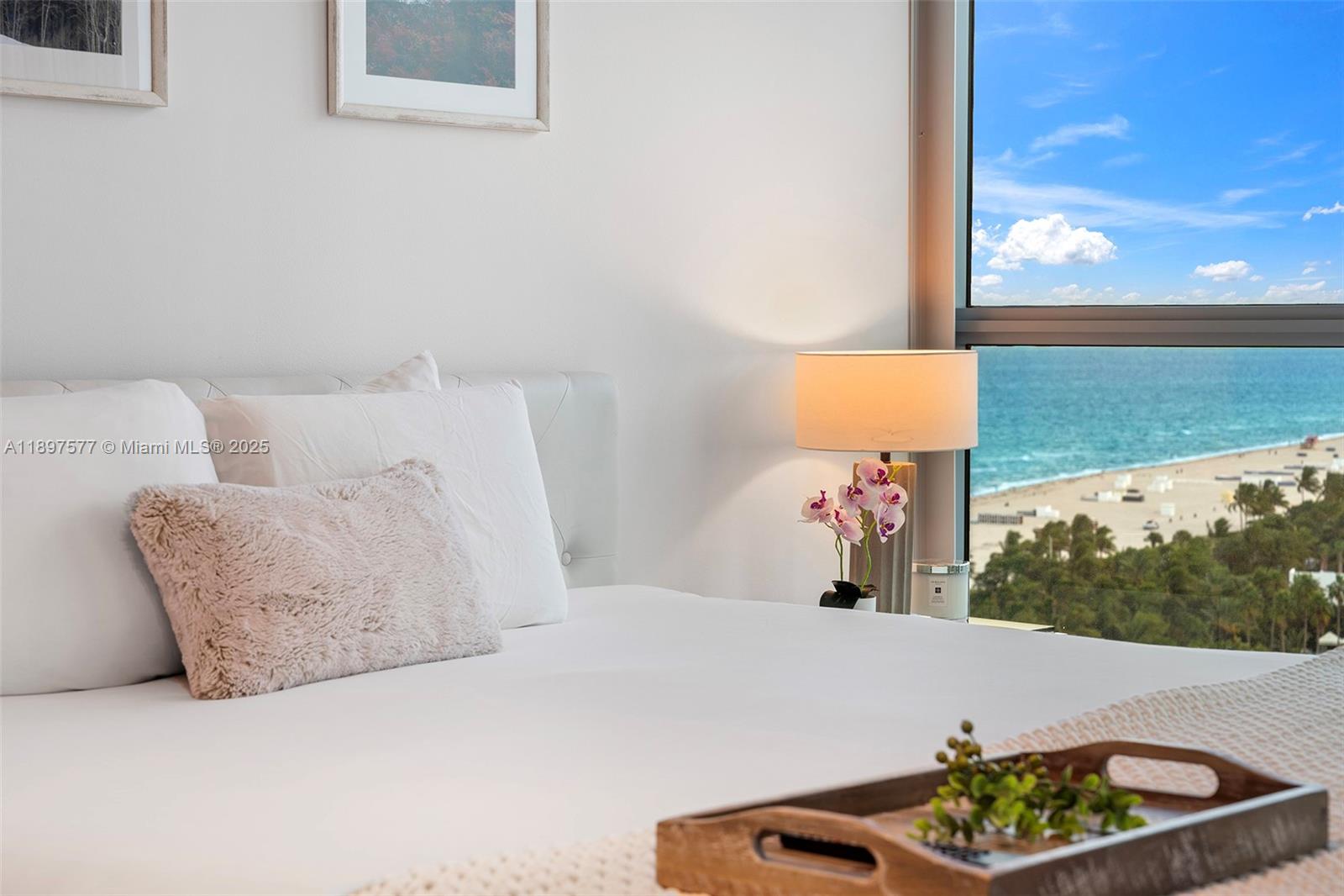 101 20th Street, Unit 2002 Miami Beach, FL 33139 - Photo 31 of 40 a bed sitting in a bedroom next to a window