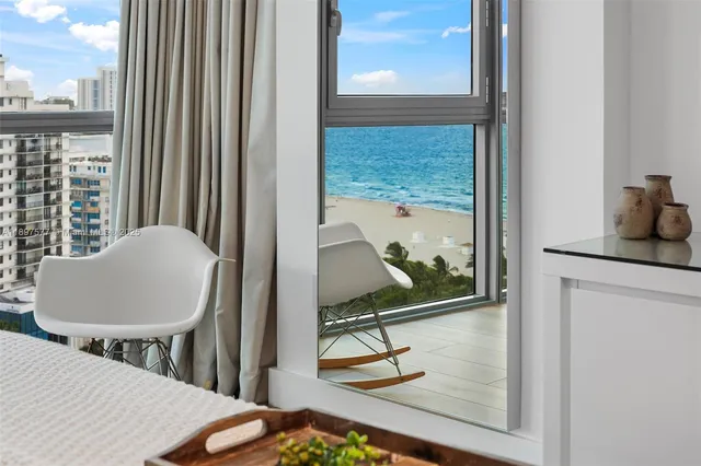 a living room with table chairs and a painting on the wall