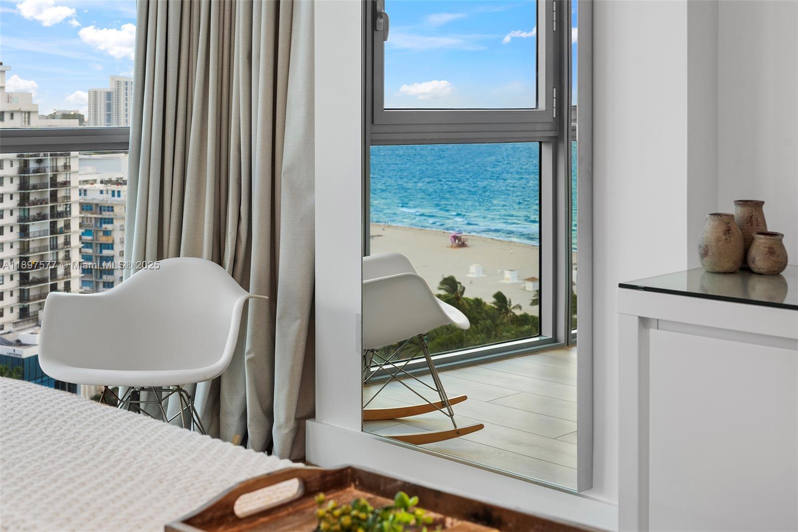 101 20th Street, Unit 2002 Miami Beach, FL 33139 - Photo 32 of 40 a living room with table chairs and a painting on the wall