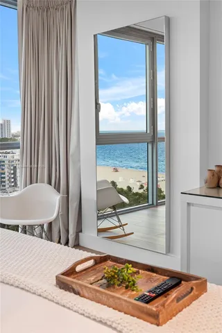 a living room with a bed and next to a window