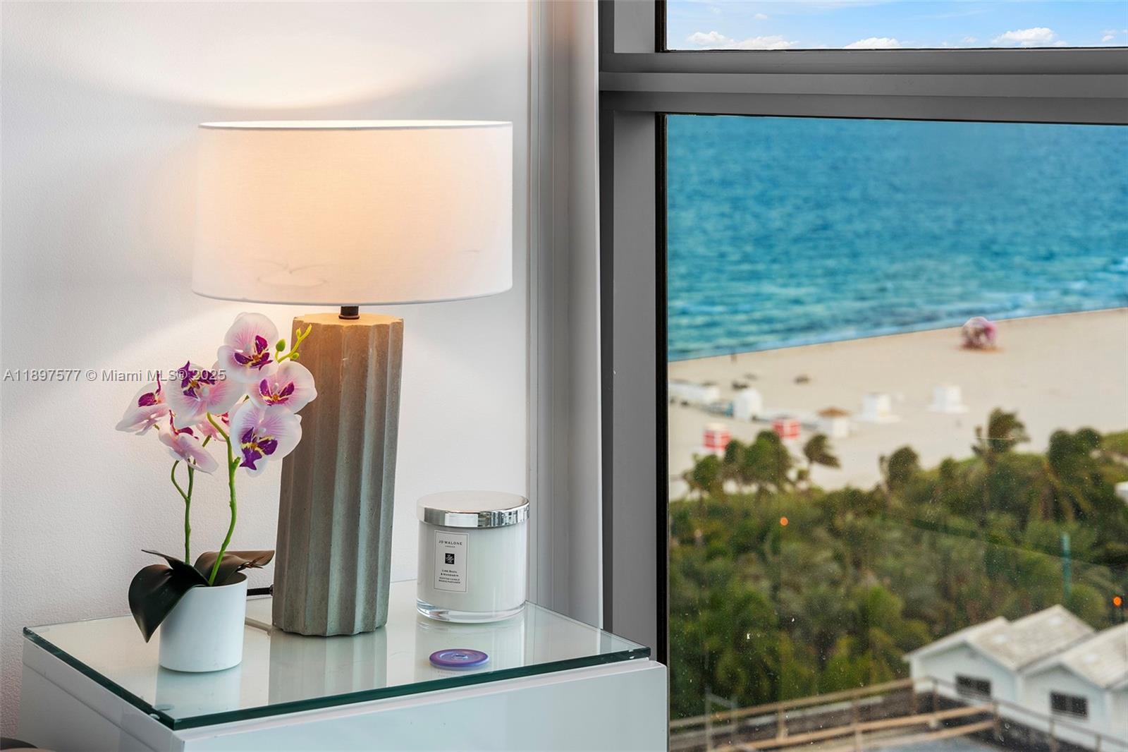 101 20th Street, Unit 2002 Miami Beach, FL 33139 - Photo 34 of 40 a vase of flowers sitting on a table with a window