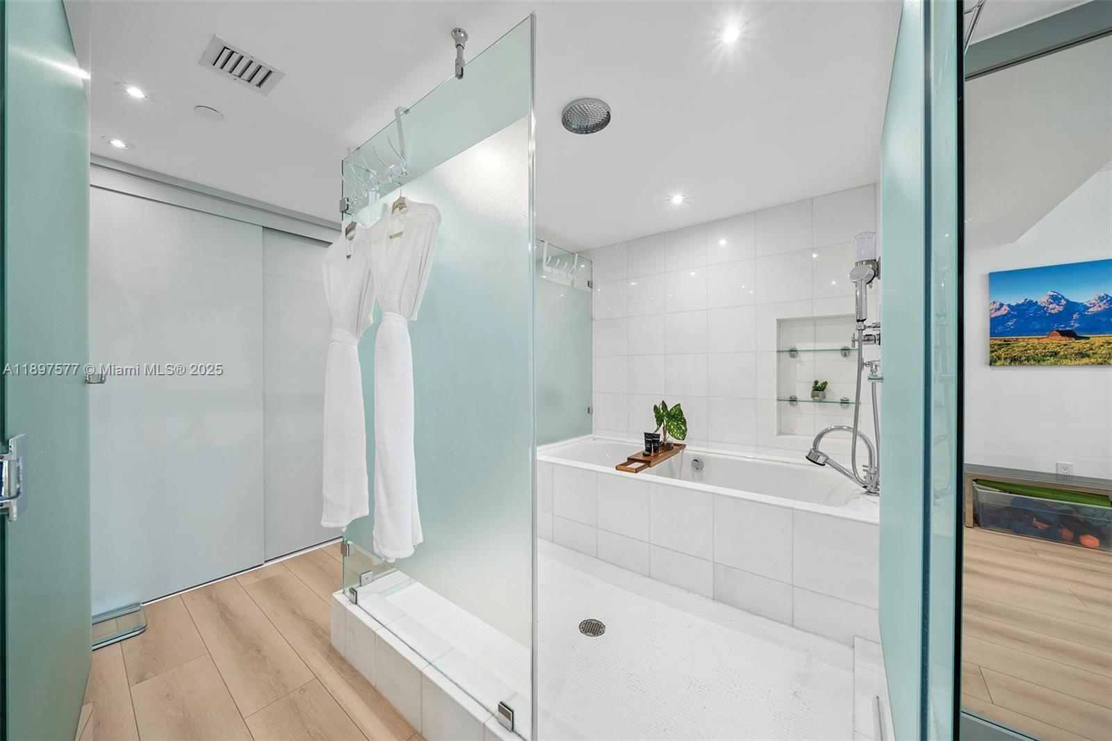 101 20th Street, Unit 2002 Miami Beach, FL 33139 - Photo 35 of 40 a bathroom with a bathtub sink vanity and mirror