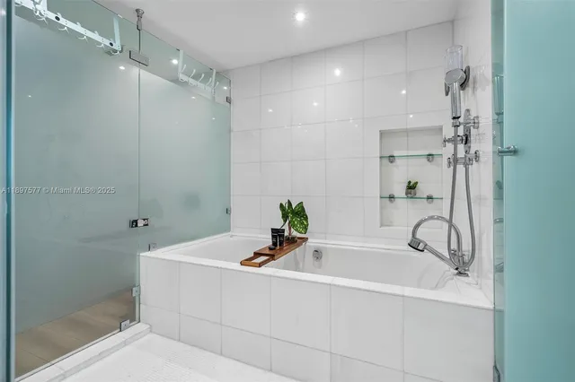 a bathroom with a bathtub and a shower