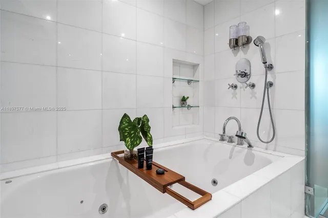a bathroom with a bathtub sink and shower