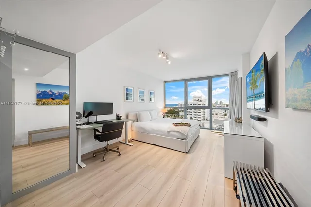 a living room with furniture a flat screen tv and a wooden floor