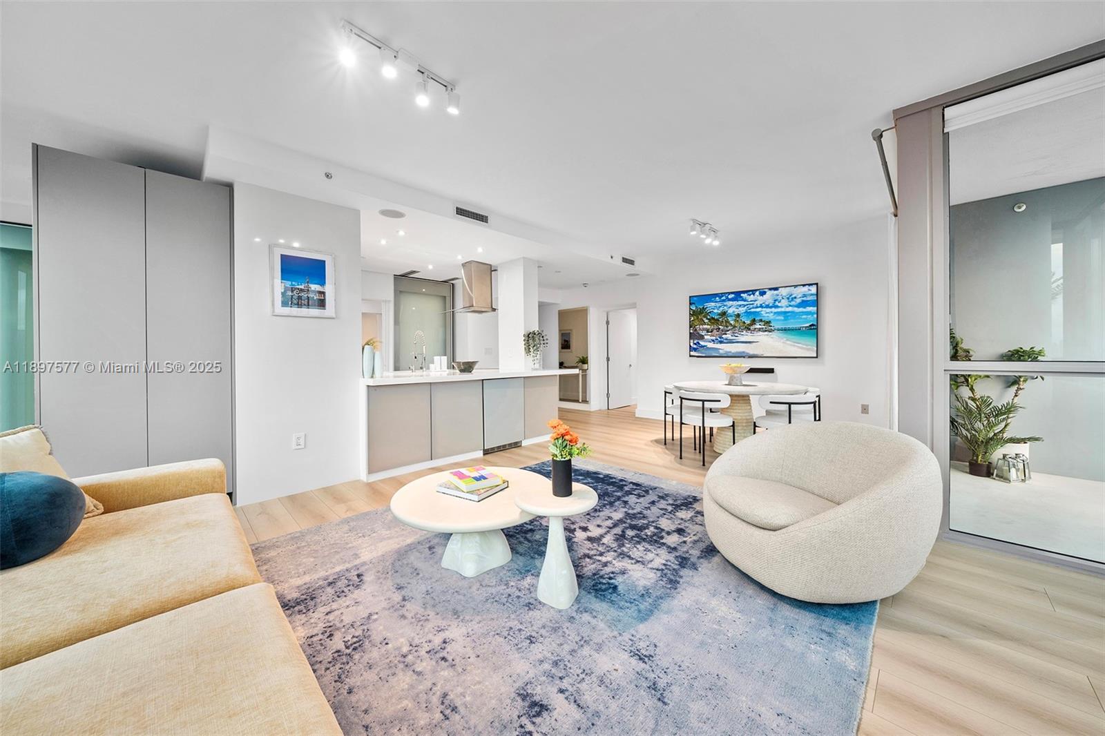 101 20th Street, Unit 2002 Miami Beach, FL 33139 - Photo 9 of 40 a living room with furniture and a wooden floor