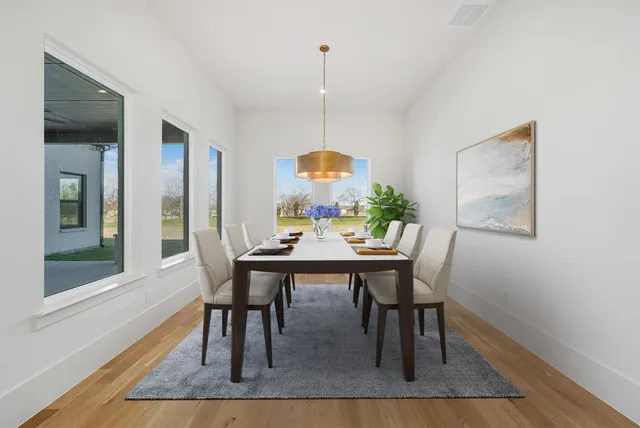 a view of a dining room with furniture window and wooden floor