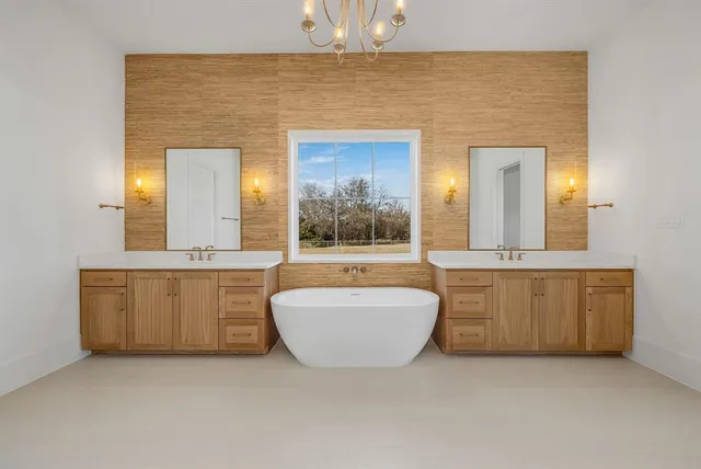 a spacious bathroom with a granite countertop sink mirror and bathtub