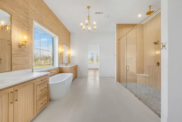 a spacious bathroom with a granite countertop sink a large mirror and a shower