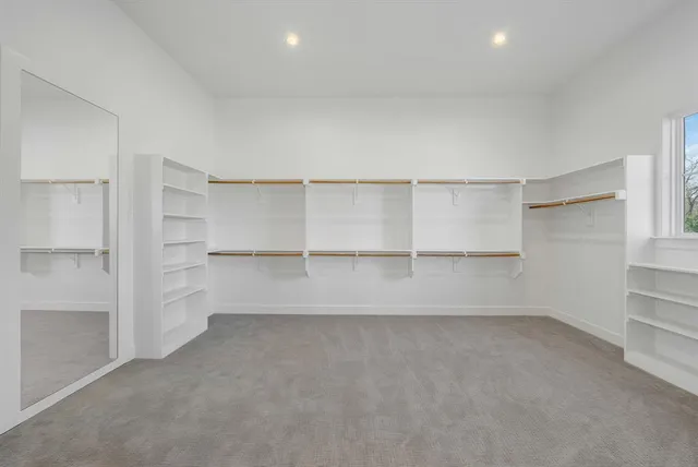 a view of an empty room with a closet