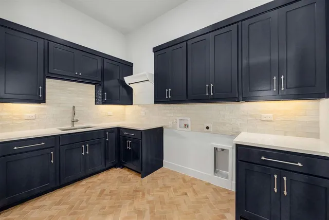 a kitchen with stainless steel appliances granite countertop wooden cabinets and a sink