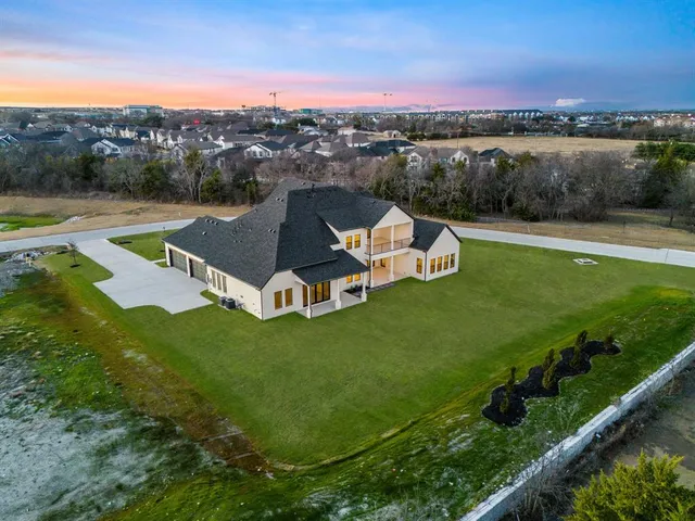 a view of a house with a yard and lake