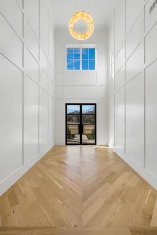 a view of an empty room with a fireplace and a window