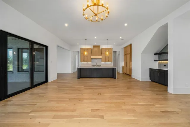 a view of kitchen and a window with kitchen in the background
