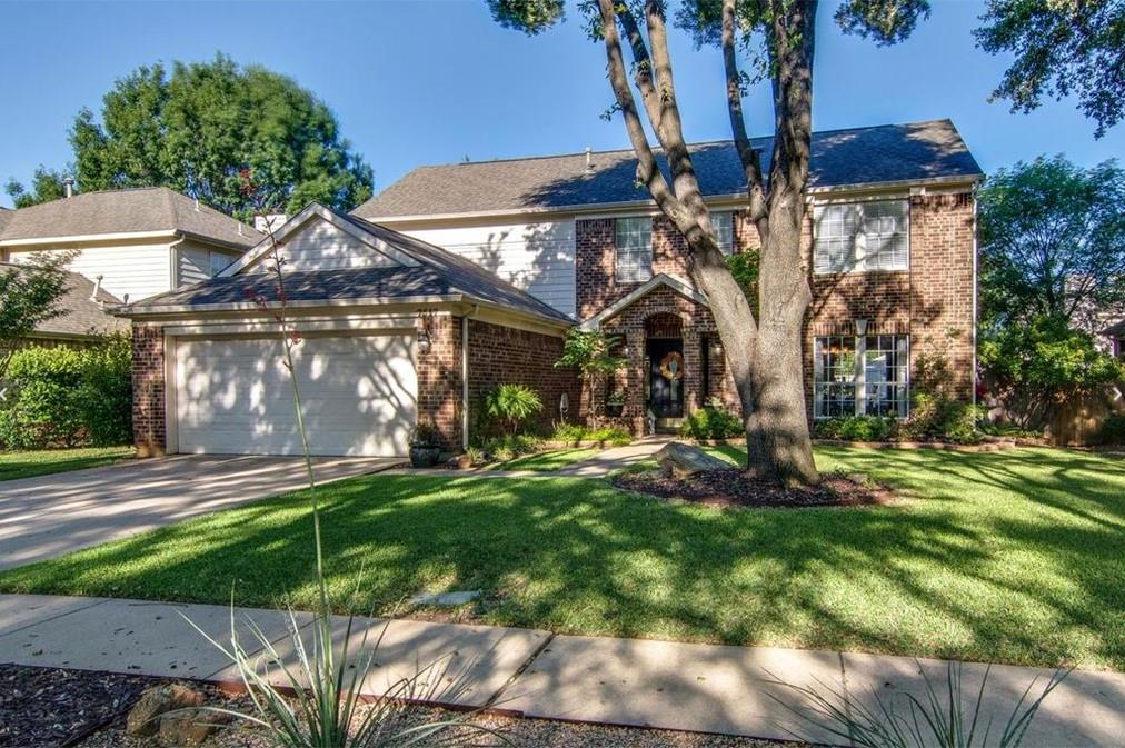 Brick and siding exterior with a prominent two-car garage