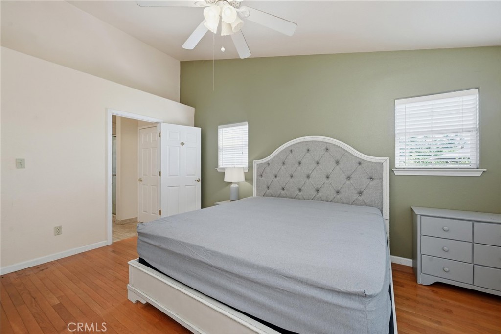 18846 Horseshoe Road Hidden Valley Lake, CA 95467 - Photo 14 of 31 a spacious bedroom with a bed and wooden floor