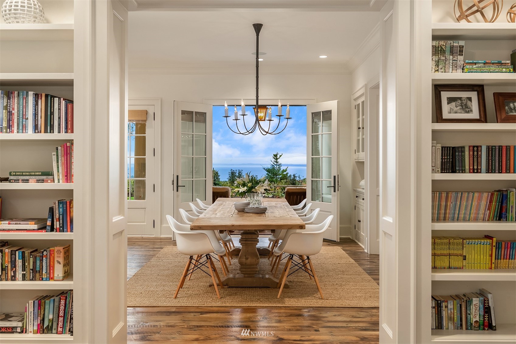 8143 Headlands Way Clinton, WA 98236 - Photo 3 of 26 a view of a dining room with furniture and book shelf