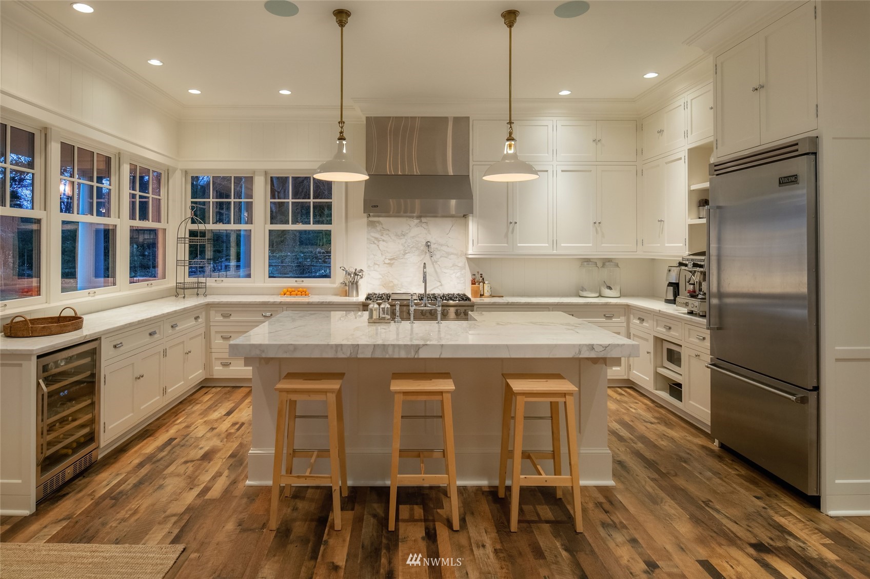 8143 Headlands Way Clinton, WA 98236 - Photo 7 of 26 a kitchen with stainless steel appliances granite countertop a sink a stove a refrigerator and island with wooden floor