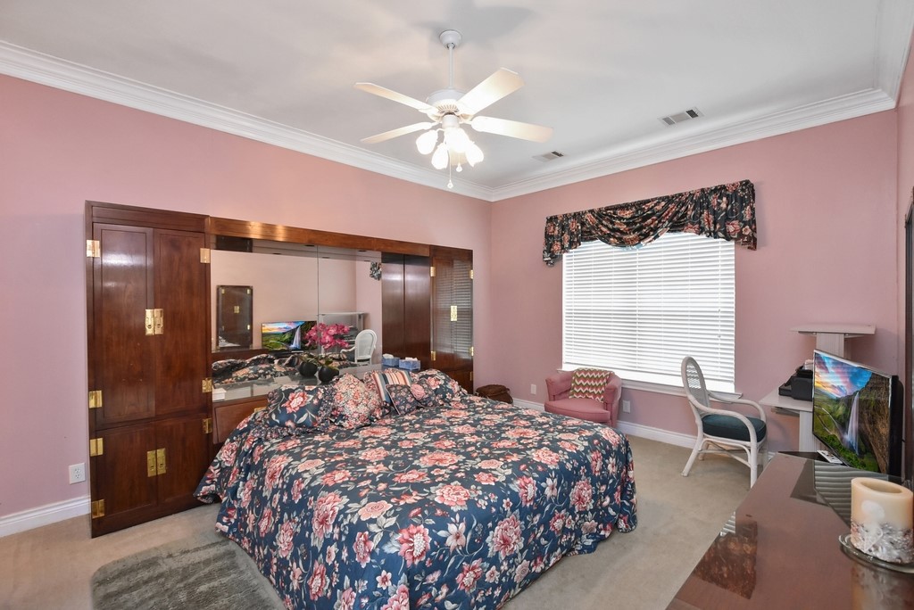 208 East 20th Street Cameron, TX 76520 - Photo 11 of 20 a bed room with a bed and a chandelier