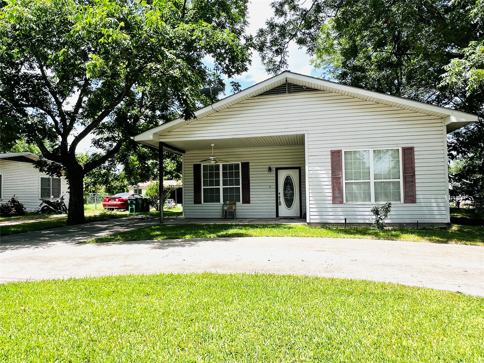 208 East 20th Street Cameron, TX 76520 - Photo 16 of 20 a front view of a house with a yard and garage