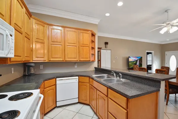 a kitchen with a sink stove and cabinets