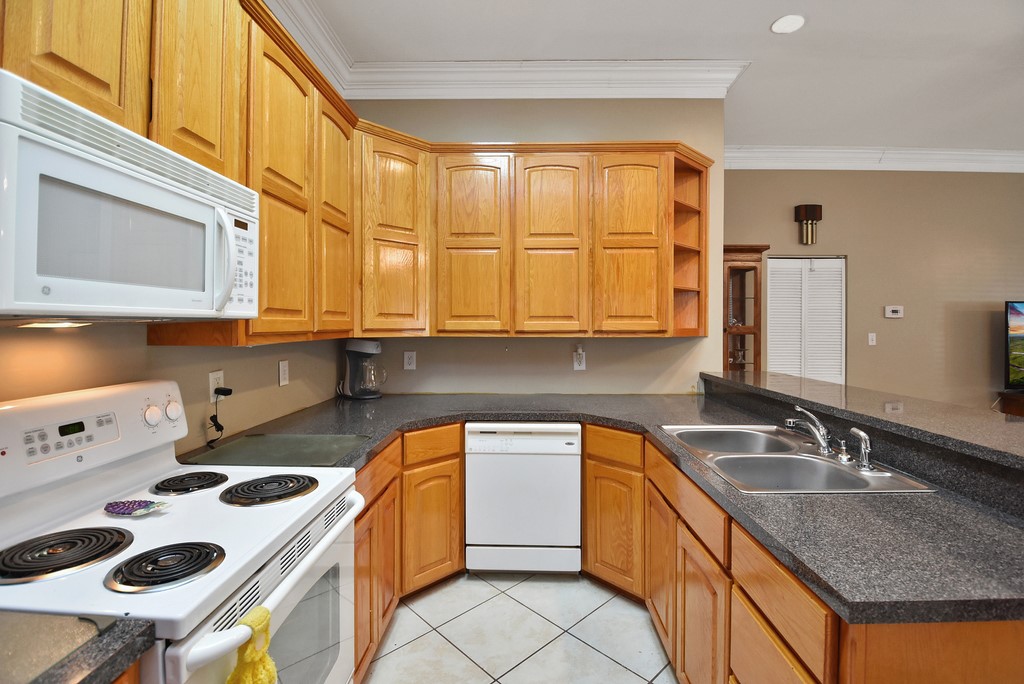 208 East 20th Street Cameron, TX 76520 - Photo 6 of 20 a kitchen that has a sink a stove and a microwave