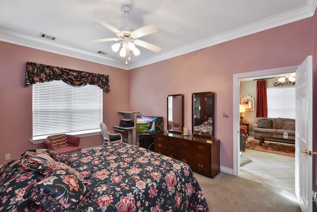 208 East 20th Street Cameron, TX 76520 - Photo 9 of 20 a bedroom with a bed and a large mirror with a desk