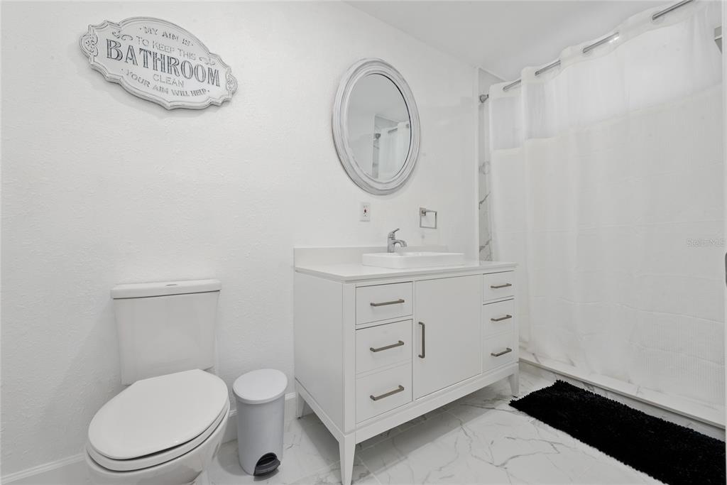 52 North York Road Avon Park, FL 33825 - Photo 31 of 44 a bathroom with a toilet a sink and a mirror