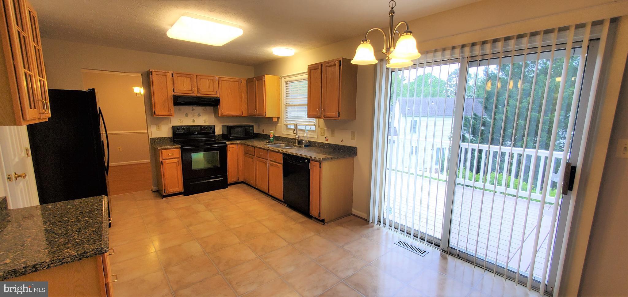 106 Lindenridge Road Laurel, MD 20724 - Photo 7 of 17 a kitchen with stainless steel appliances granite countertop a stove a sink and a refrigerator