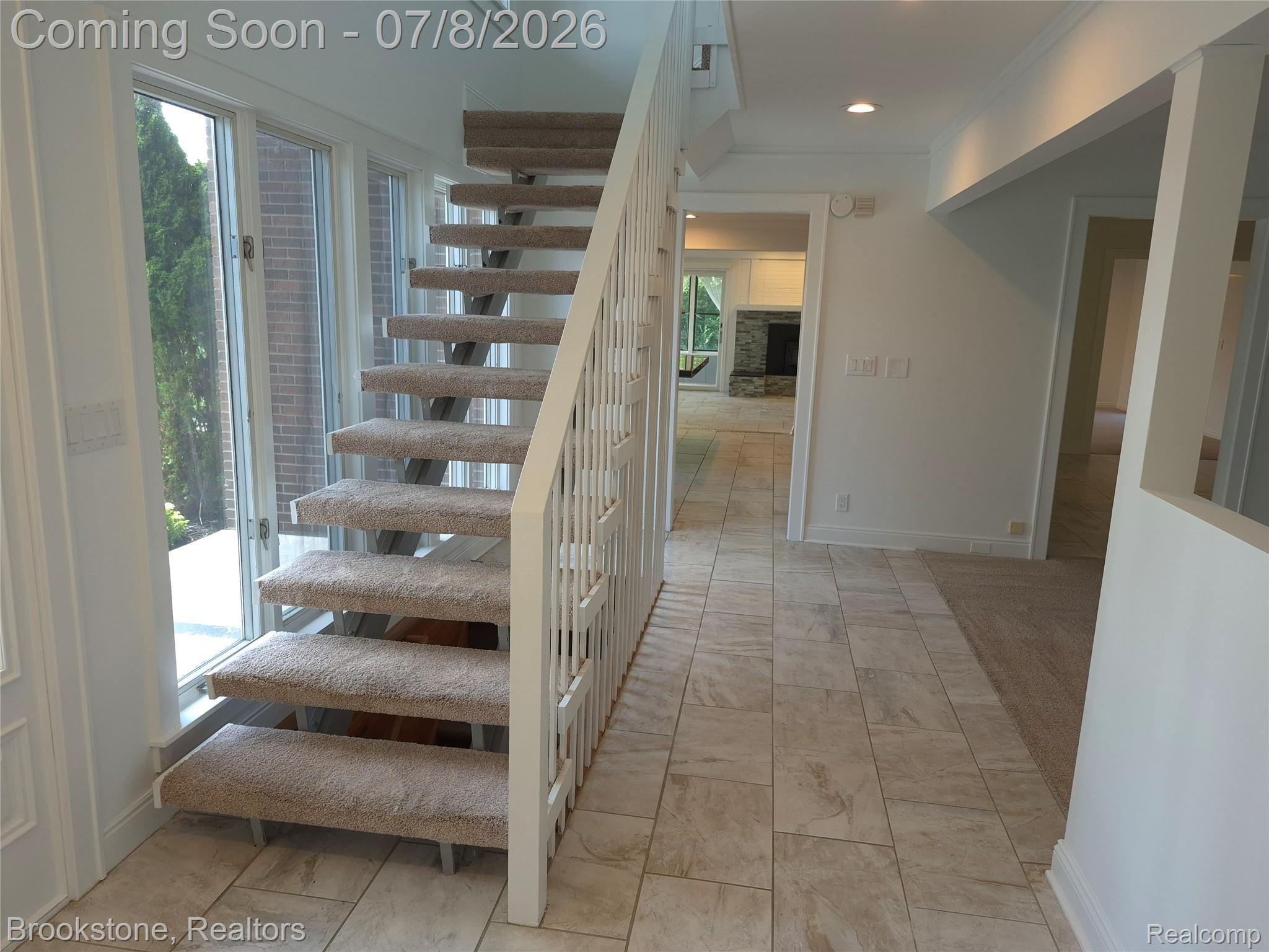 4140 South Henderson Road Davison, MI 48423 - Photo 19 of 98 Open-tread staircase with carpeted steps and white railing