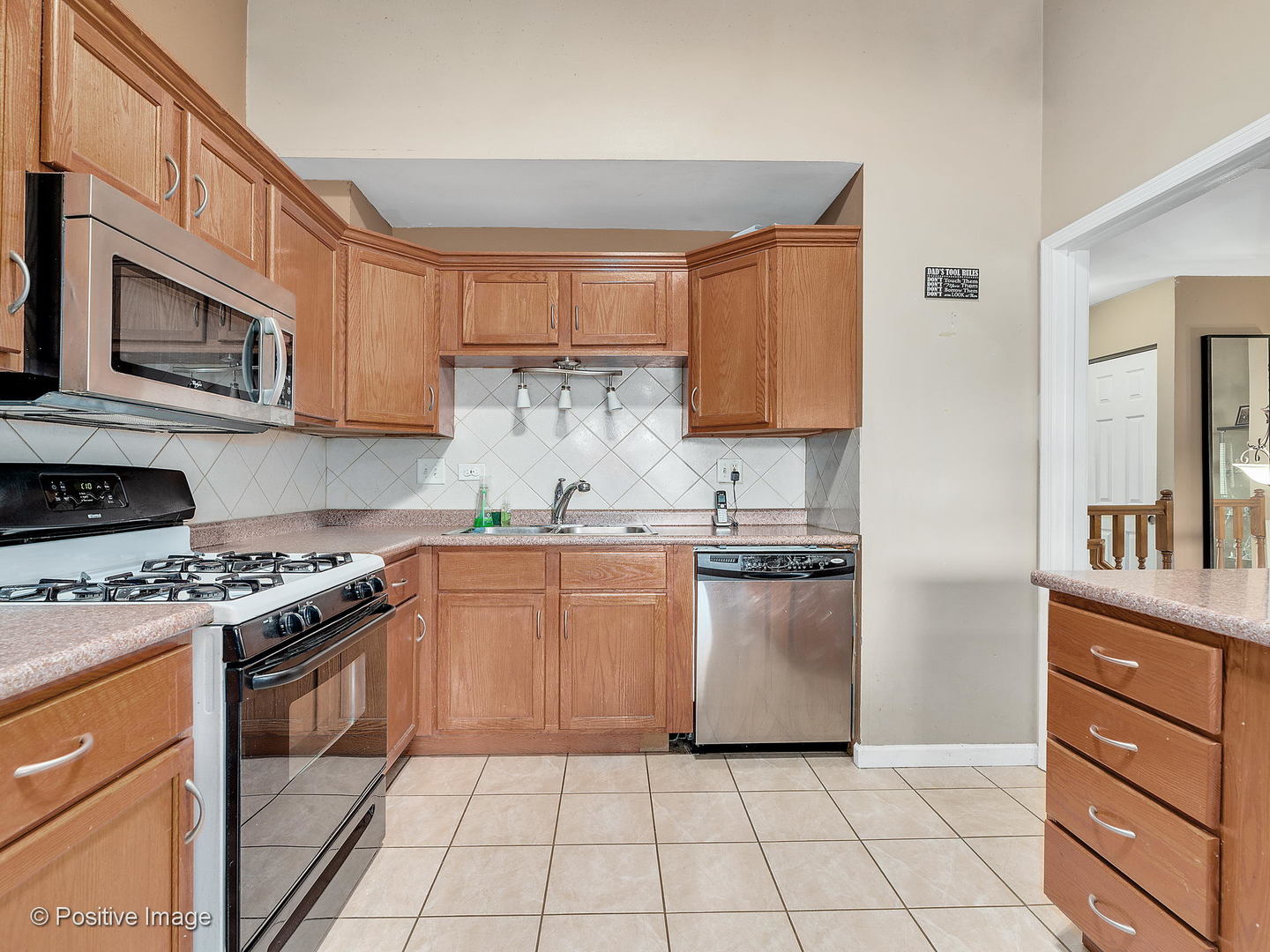 773 High Ridge Road Roselle, IL 60172 - Photo 7 of 18 a kitchen with granite countertop cabinets stainless steel appliances and a sink