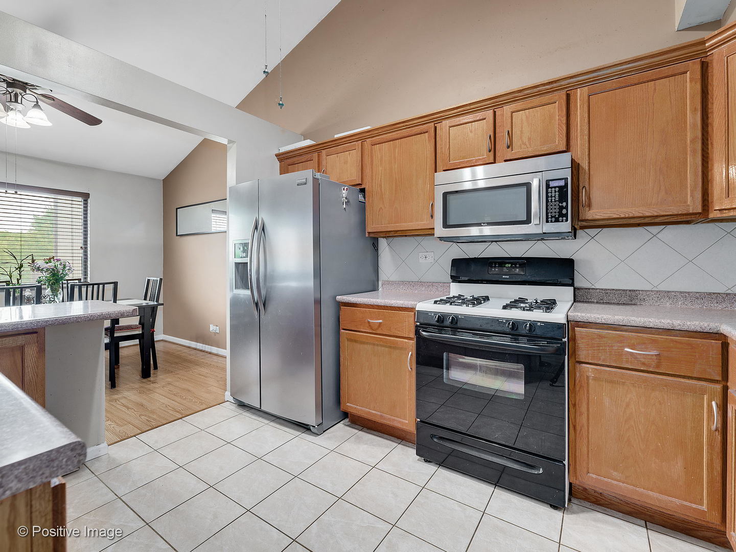 773 High Ridge Road Roselle, IL 60172 - Photo 10 of 18 a kitchen with stainless steel appliances granite countertop a stove a microwave a sink and cabinets