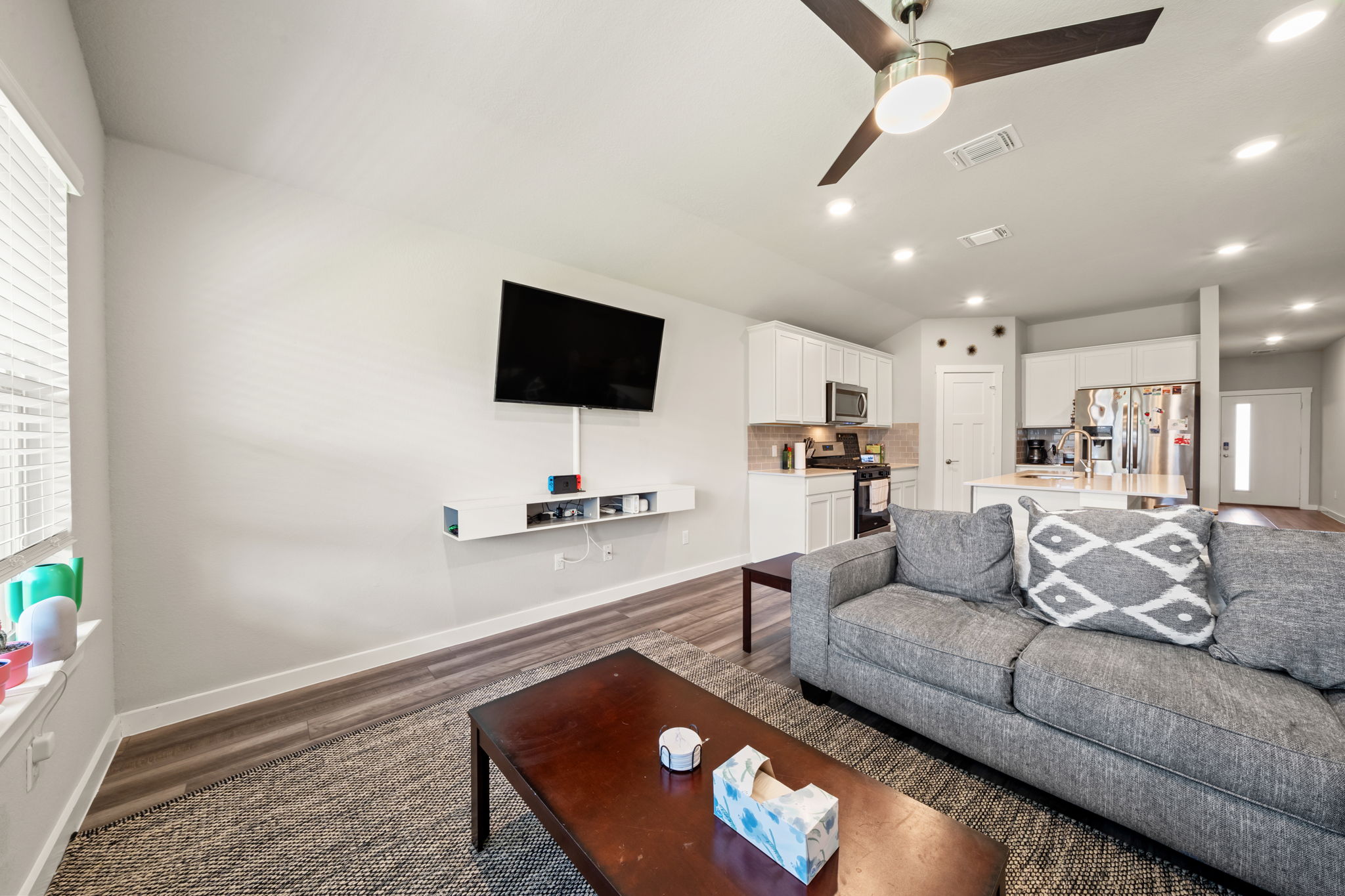 1117 Tipton Street Georgetown, TX 78633 - Photo 14 of 40 Open-concept living area featuring a ceiling fan with integrated lighting, recessed ceiling lights, and wood-finish flooring
