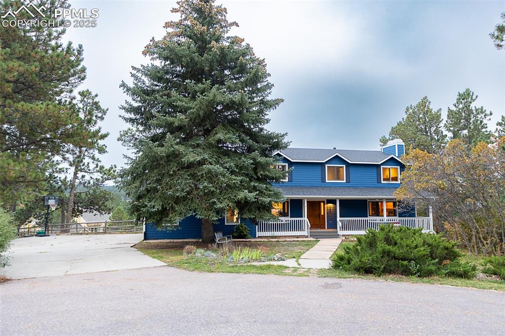 555 Hidden Marsh Road Monument, CO 80132 - Photo 1 of 47 a front view of house with yard and trees around