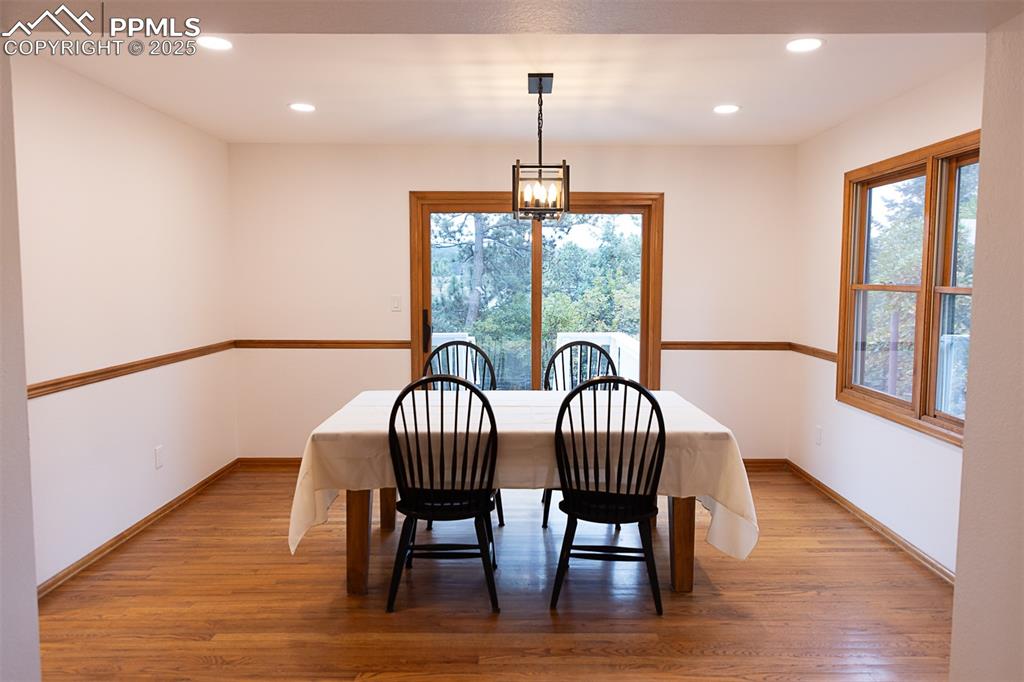 555 Hidden Marsh Road Monument, CO 80132 - Photo 13 of 47 a view of a dining room with furniture window and wooden floor