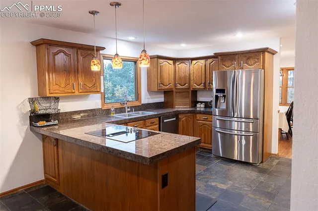 a kitchen that has a sink cabinets counter space and stainless steel appliances