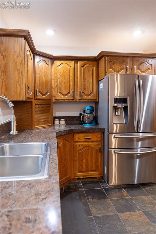 555 Hidden Marsh Road Monument, CO 80132 - Photo 16 of 47 a kitchen with stainless steel appliances granite countertop a refrigerator and a sink