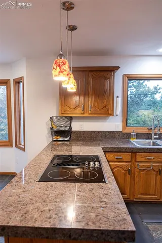 a kitchen with sink stove and window