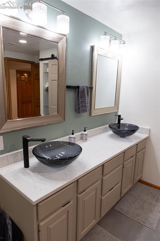 555 Hidden Marsh Road Monument, CO 80132 - Photo 25 of 47 a bathroom with a sink and a mirror