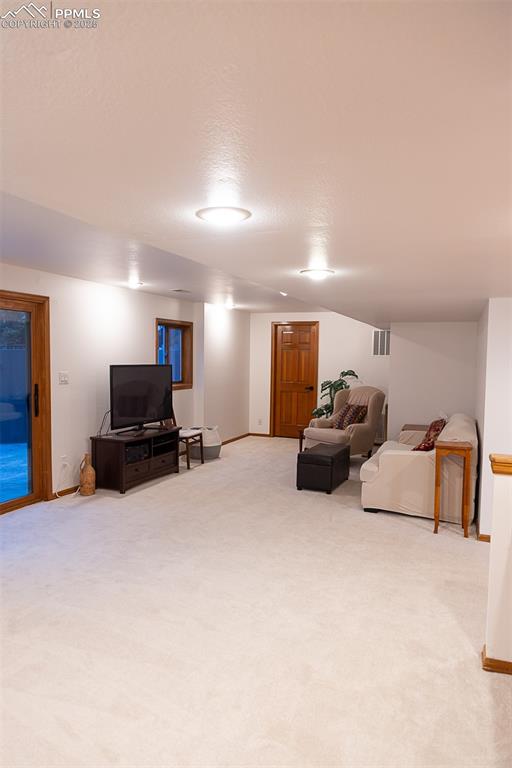 555 Hidden Marsh Road Monument, CO 80132 - Photo 29 of 47 a living room with furniture and a flat screen tv