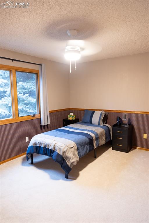 555 Hidden Marsh Road Monument, CO 80132 - Photo 37 of 47 a bedroom with a bed and a window