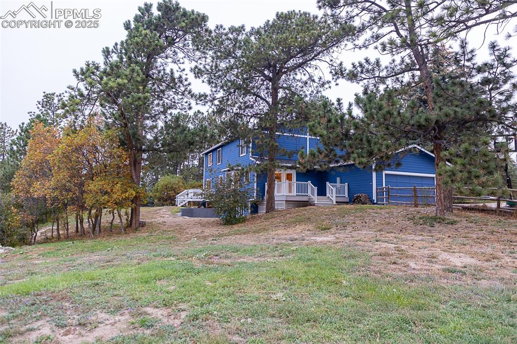 555 Hidden Marsh Road Monument, CO 80132 - Photo 45 of 47 a wooden house with large trees in front of it