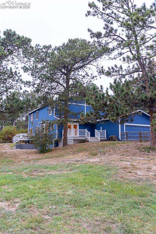 555 Hidden Marsh Road Monument, CO 80132 - Photo 46 of 47 a view of a house with a yard
