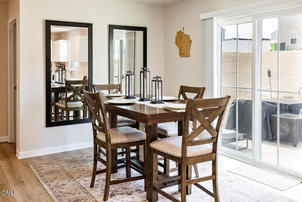 4468 Captain Falls Drive Raleigh, NC 27610 - Photo 11 of 36 a view of a dining room with furniture and a window