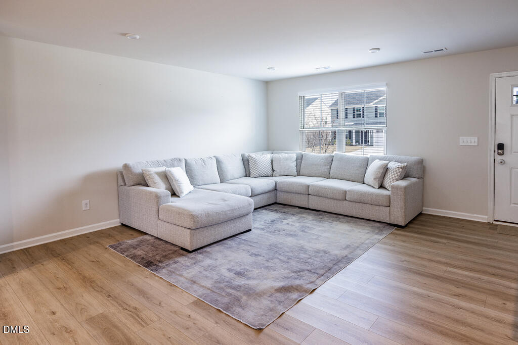 4468 Captain Falls Drive Raleigh, NC 27610 - Photo 12 of 36 a living room with furniture and a couch