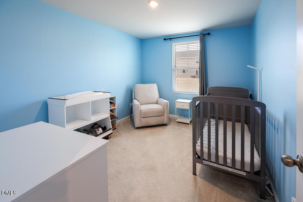 4468 Captain Falls Drive Raleigh, NC 27610 - Photo 16 of 36 a bedroom with a bed and a chair