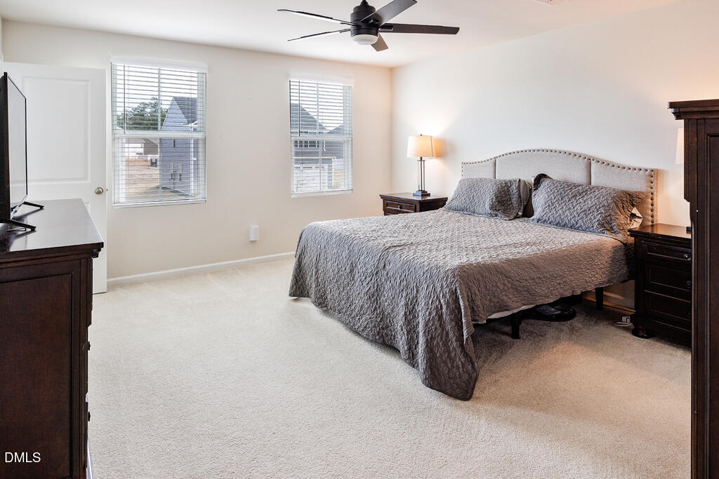 4468 Captain Falls Drive Raleigh, NC 27610 - Photo 18 of 36 a spacious bedroom with a bed and a window