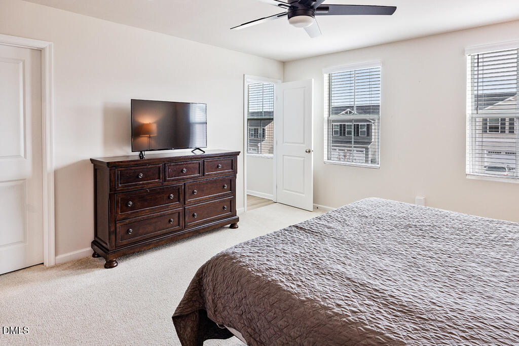 4468 Captain Falls Drive Raleigh, NC 27610 - Photo 19 of 36 a bedroom with a bed and flat screen tv