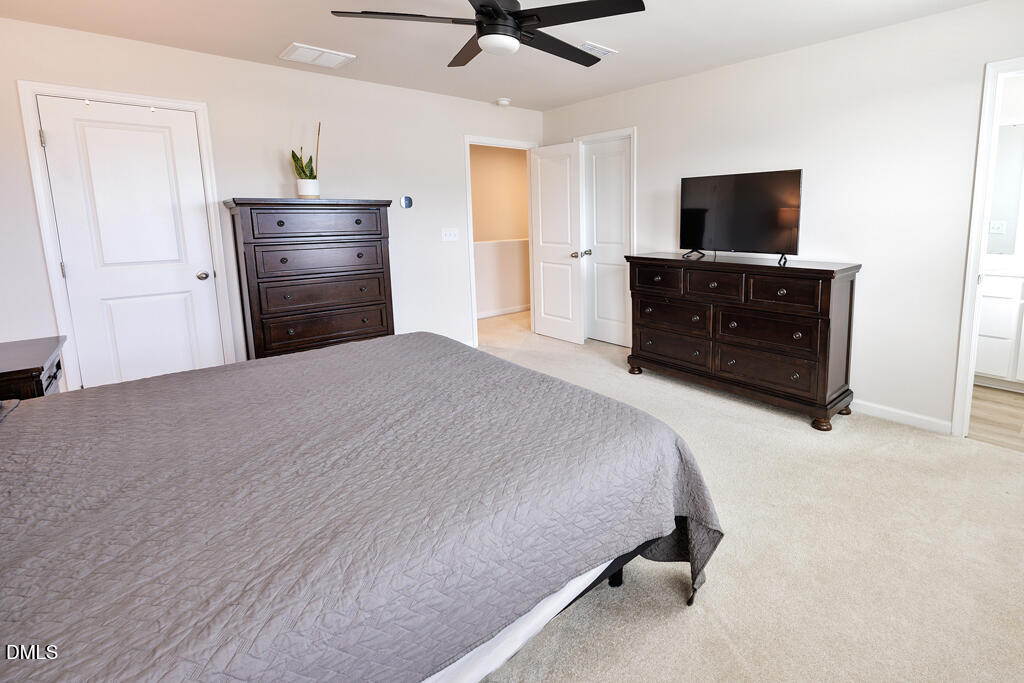 4468 Captain Falls Drive Raleigh, NC 27610 - Photo 20 of 36 a bedroom with a bed and a television