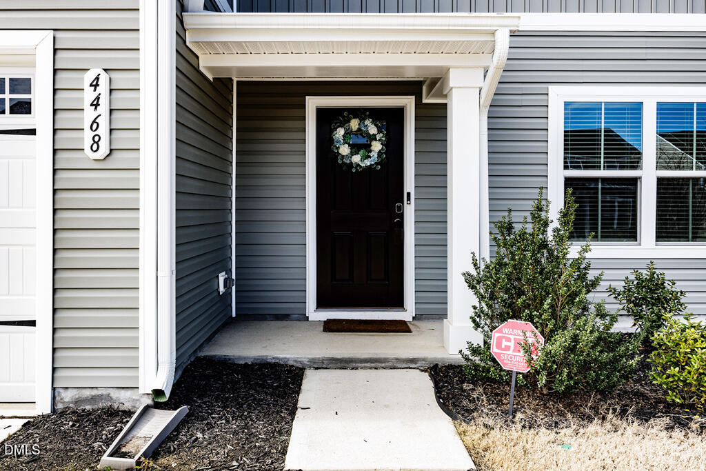 4468 Captain Falls Drive Raleigh, NC 27610 - Photo 2 of 36 a front view of a house with a potted plant